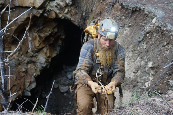 Frank working his rope gear at a mine opening in the hillside