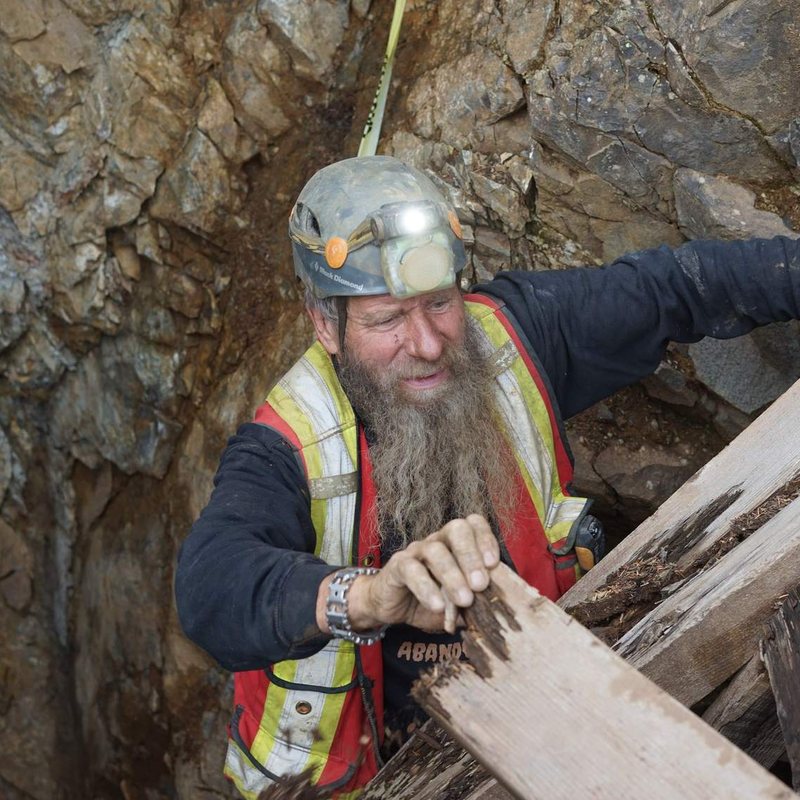 Frank Schlichting grinning in the old workings at Phoenix, on the cover of the record